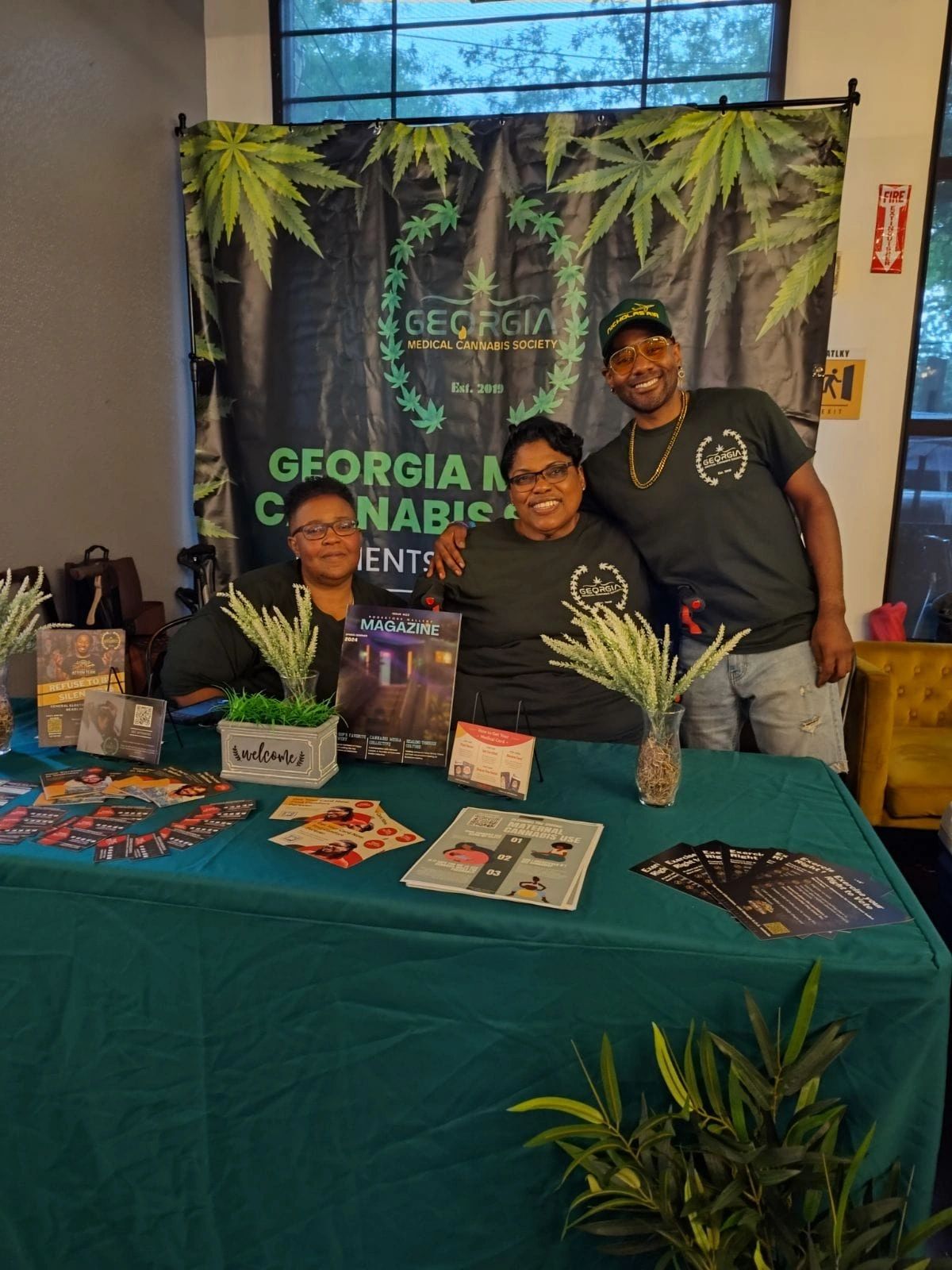 Georgia Medical Cannabis Society team at a community event booth, Est. 2019